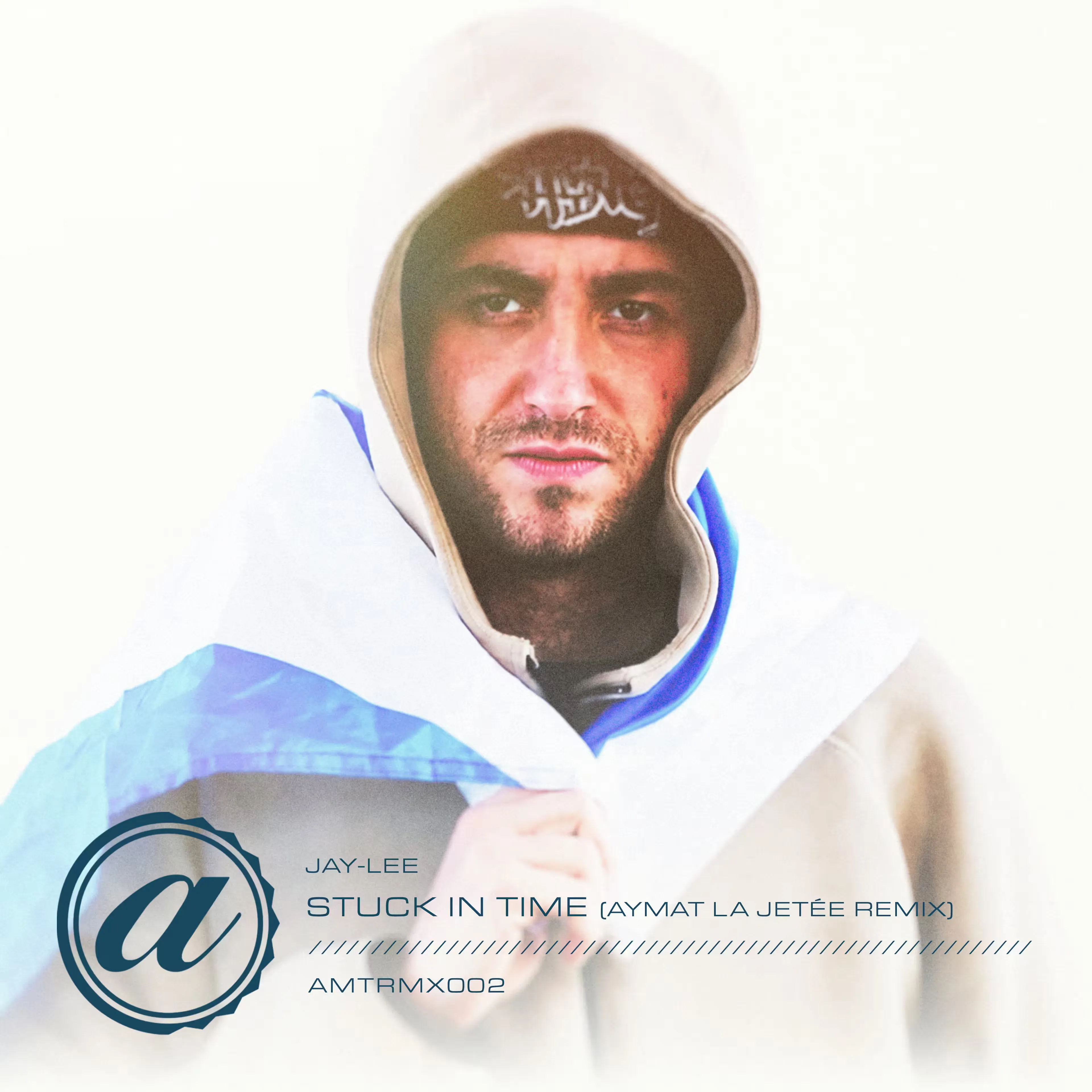 Digital album cover for the Jay-Lee "Stuck In Time" (Aymat La Jetée Remix) release, showing text and a stylized logo over a white backdrop with a close-up of a man in a hooded beige coat staring intensely at the camera, wrapped in a blue and white Scottish flag.