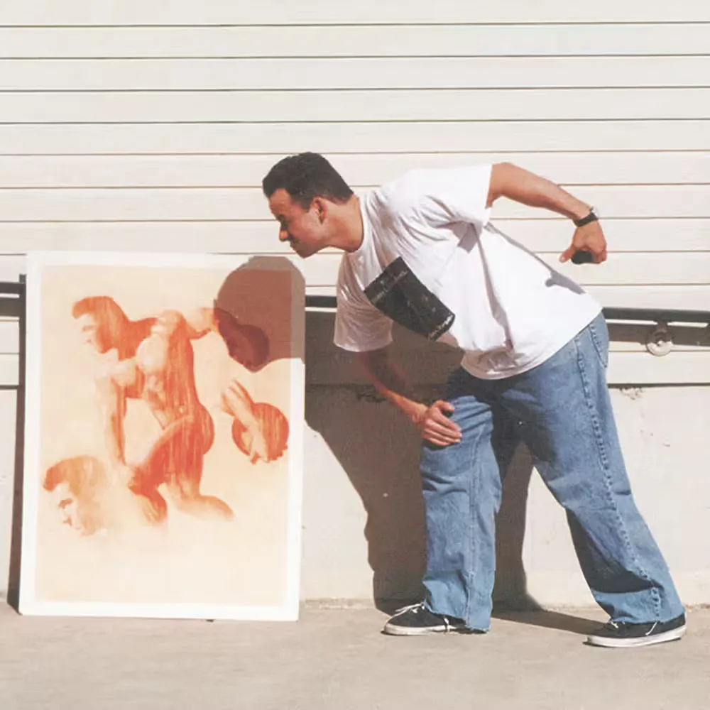 A man leans toward a painting propped against a wall, mimicking the pose of one of the figures depicted in the artwork.